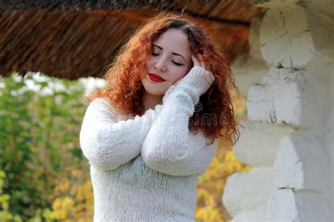 Portrait A Woman Model With Closed Eyes She Stands Near The Old House In A White Knitted