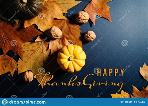Happy Thanksgiving Day With Maple Leaves Nut And Pumpkin On Blue