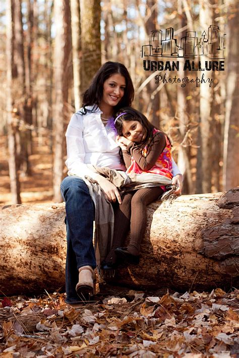 pose of mother an daughter love the sitting on a log in the woods mother daughter pictures