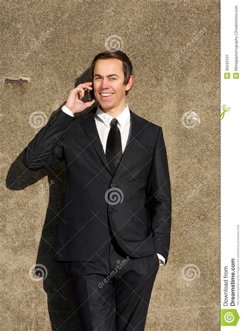 Confident Young Business Man Talking On Mobile Phone Outdoors Stock
