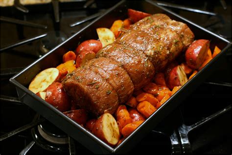 Season pork with salt and pepper (add chopped fresh herbs to taste). pork roast and potatoes in the oven