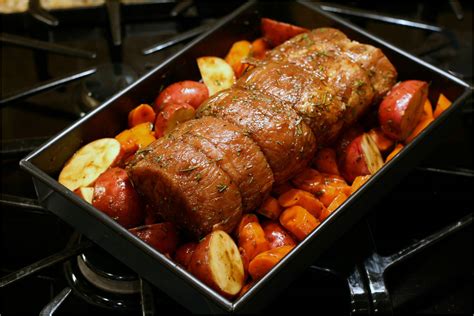 Season the pork tenderloins with salt and pepper. pork roast and potatoes in the oven