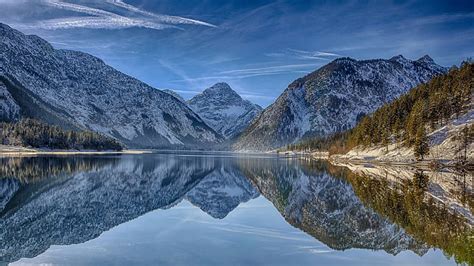Mirrored Lake Plansee In The Austrian Tyrols Forest Mountains