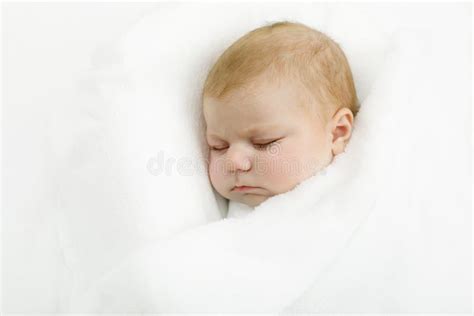 Cute Little Newborn Baby Girl Sleeping Wrapped In Blanket Stock Image