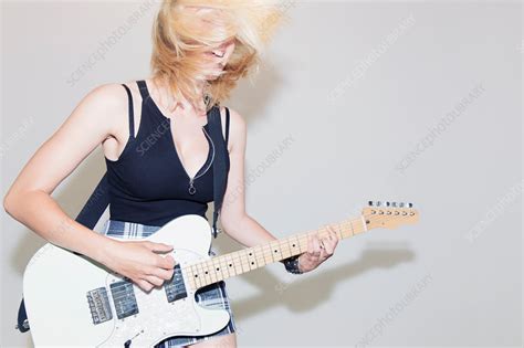 Exuberant Young Woman Playing Electric Guitar Stock Image F0239003