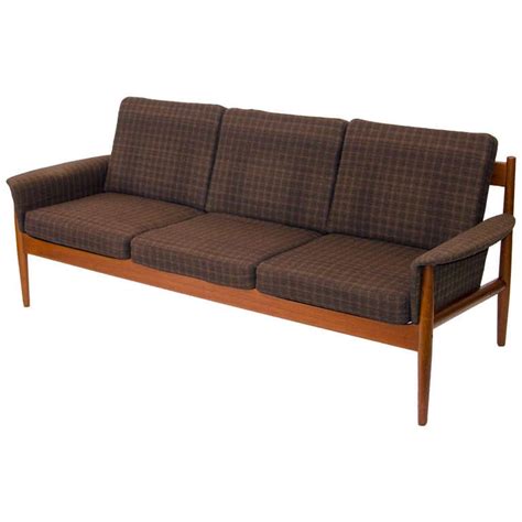 Made with a solid wood frame, this handsome design features gray velvet upholstery with high density foam fill, two plush toss pillows, and gleaming chrome sled legs. Mid Century Danish Teak Sofa - Grete Jalk at 1stdibs