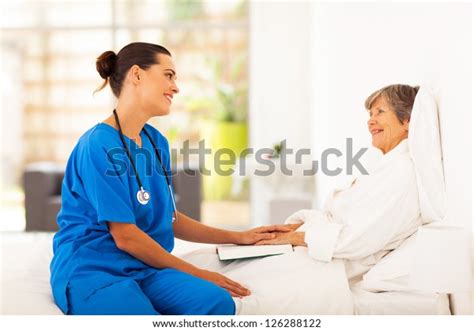 Friendly Nurse Visiting Recovering Senior Patient Stock Photo Edit Now