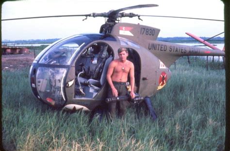 A Man Standing In Front Of A Helicopter