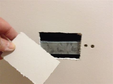 The disc has been covered with spackle and i'm ready to sand. How to repair a power point hole in a plaster wall ready for painting. | TMZ Painting