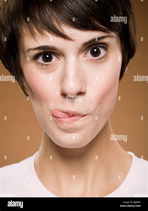 Woman making funny face with eyes crossed and puckered lips Stock Photo ...