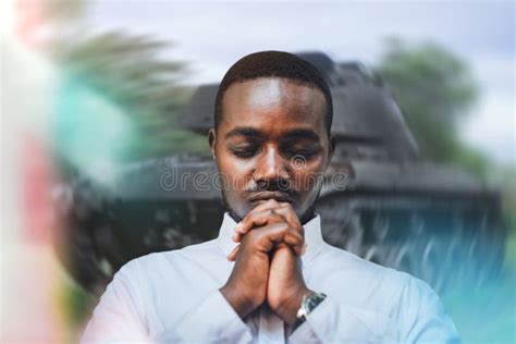 Portrait Of African Man Praying Mature Man With Military Tank
