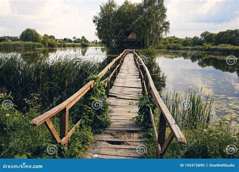 Landscape View Of Old Small Wooden Bridge Across The Lake Fishman