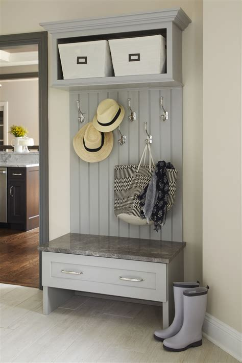 A pale blue-grey mudroom remodel- ELLEDecor.com Mudroom Storage Bench