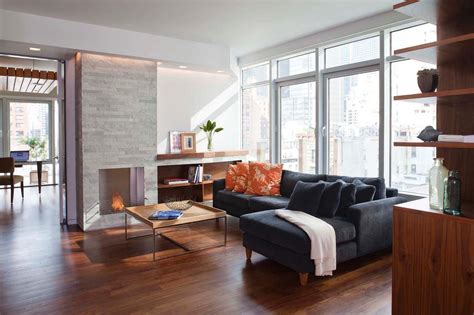 A white sofa matching the wall and floors sets the stage for. Modern Urban Living Room With White Stone Fireplace | HGTV