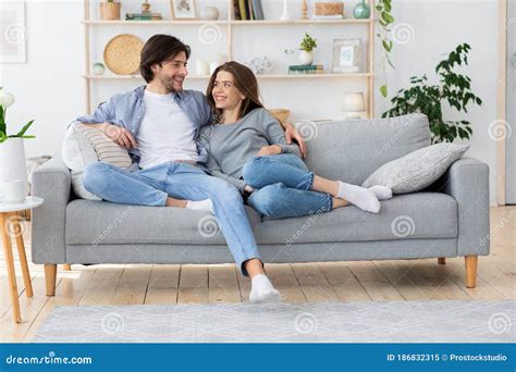 Couple In Love Hugging On Sofa Looking At Each Other Stock Image Image Of Living Cuddle