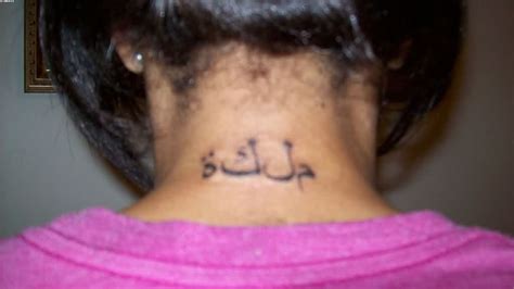 Fabulous Black Color Ink Arabic Tattoo Design On Back Neck For Girls