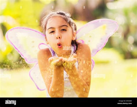 Girl 8 9 Blowing Fairy Dust Stock Photo Alamy