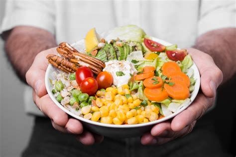 Free Photo Close Up Of Man Holding Bowl Of Healthy Food