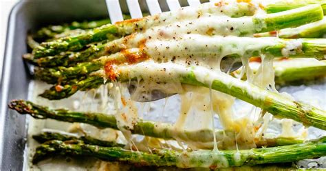 Place the asparagus on a baking sheet, drizzle with olive oil, then toss to coat the asparagus completely. Cheesy Baked Asparagus