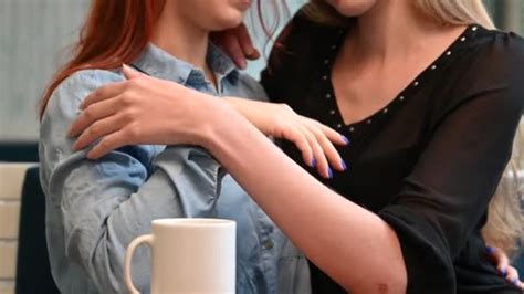 Portrait Of Two Women In Homosexual Relationships Gently Caress Each Other And Drink Coffee