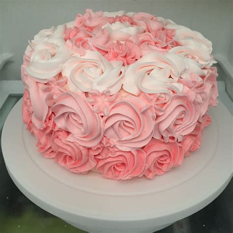 A Pink And White Cake Sitting On Top Of A Counter
