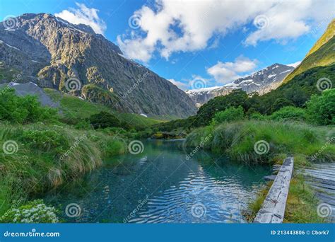 Wooden Bridge Over River In The Mountains Fiordland New Zealand Stock