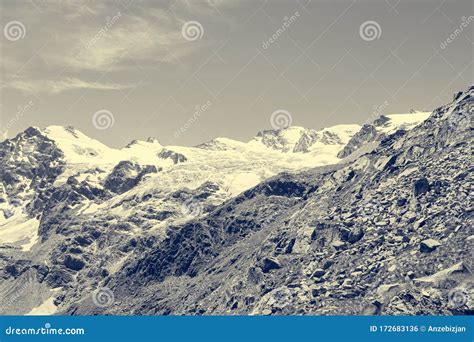 Spectacular Mountain Panorama With Peaks And Slopes Covered With Glaciers Above Lush Green