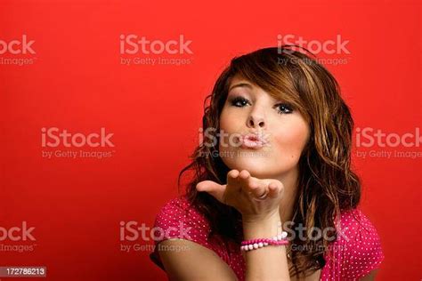 Attractive Young Woman Blowing A Kiss Stock Photo Download Image Now