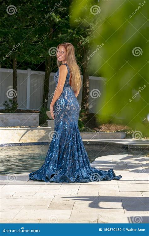 A Lovely Brunette Elegant Model Enjoys The Poolside Before Prom Stock