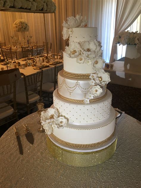 The 'wedding breakfast' does not mean the meal will be held in the morning, but at a time following the ceremony on the same day. 5 tiered white gold wedding cake with sugar flowers | Flickr