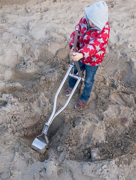 Small Boy Digging In A Sand Pit Stock Photo Image Of Energy Coat