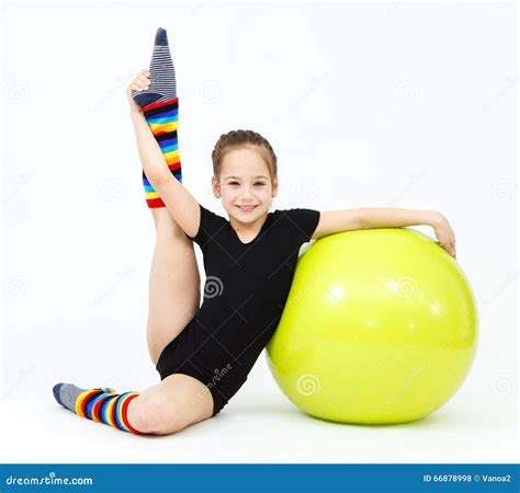 Flexible Teen Girl Doing Gymnastics Exercises On Fitness Ball Stock