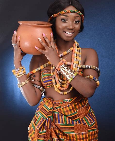 an african woman holding a pot and wearing bracelets