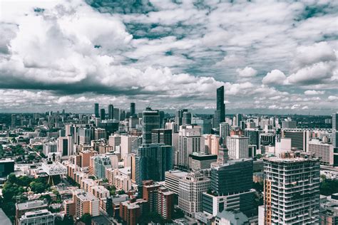 High Angle View Of Cityscape Against Cloudy Sky · Free Stock Photo