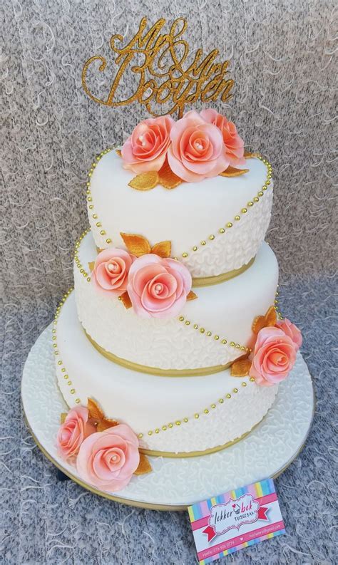 3 Tier Wedding Cake With Peach Coloured Fondant Roses And Gold Accents