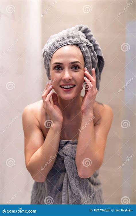 Side View Of Pretty Female With Towel On Head And In Bathrobe Posing Portrait Of Woman With
