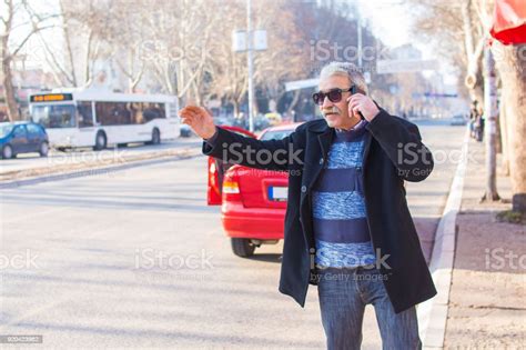 Elderly Man In A Hurry Calling A Taxi Stock Photo Download Image Now