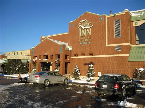 two cars are parked in front of the inn