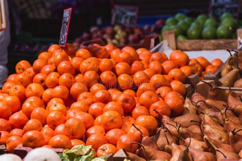 Fresh Organic Orange Mandarins Pears Avocado In Market Stock Photo