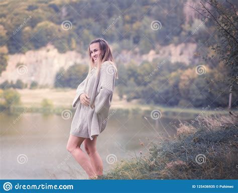 Girl In A Warm Sweater Against The Background Of Nature Stock Image