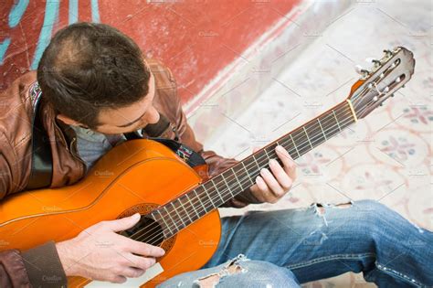 Man Playing Guitar In The Street Containing Outdoor Handsome And