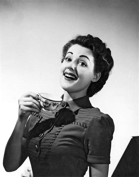 A Perky Woman Enjoys Her Cup Of Coffee Photograph By Underwood Archives