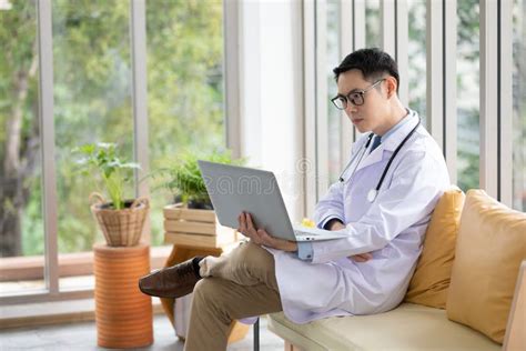 Doctor Using Laptop Computer And Thinking Something Stock Photo Image