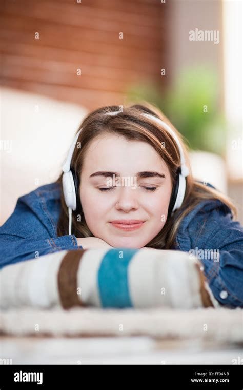 Pretty Woman Listening Music Lying On The Floor Stock Photo Alamy