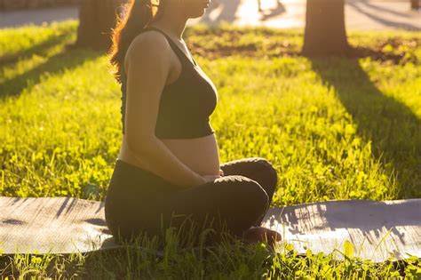 Premium Photo Closeup Of Pregnant Woman Meditating In Nature Practice Yoga Care Of Health And