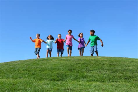 Children Holding Hands And Running Over Hill Stock Photo Download