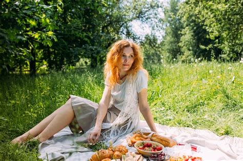 Premium Photo Beautiful Redhead Woman On Picnic She Smiles Eat Strawberrie And Enjoys Summer
