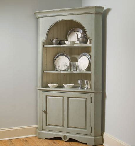 An antique style side cabinet such as this matches flawlessly with the traditional décor of this dining room that is dominated by a conventional dining table. Corner cupboard designs pictures. | An Interior Design