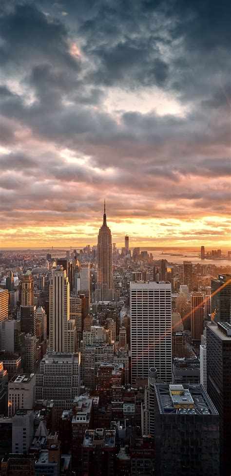 Download 1440x2960 New York Sunset Dark Clouds Buildings Cityscape