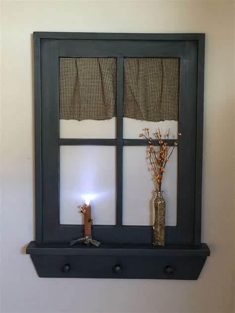 Throw in a few tea lights below in attractive containers, and you have the unique charm of simple living right above your mantle. Primitive window | Wall lights, Candle sconces, Primitive ...